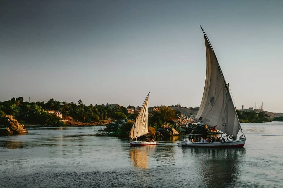 Feluccas sailing on the Nile at sunset