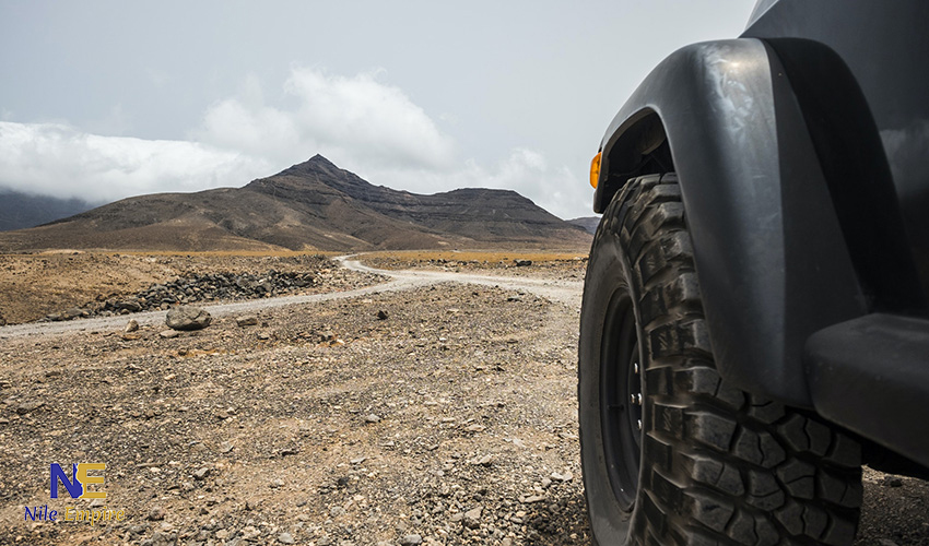 A convoy of tourists on an ATV safari in Hurghada navigating the dusty trails at sunset