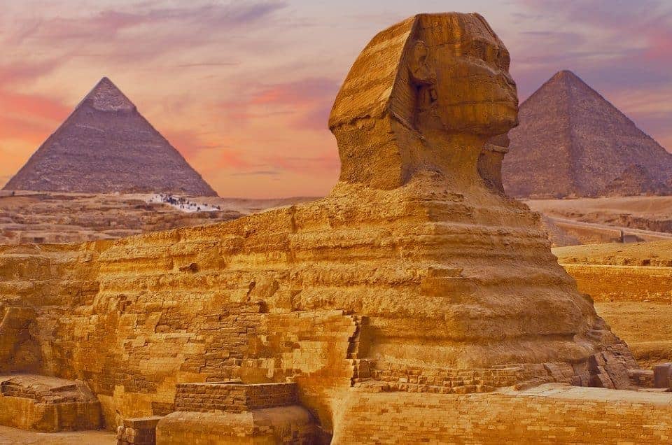 Sphinx against the backdrop of the great Egyptian pyramids. Africa, Giza Plateau.