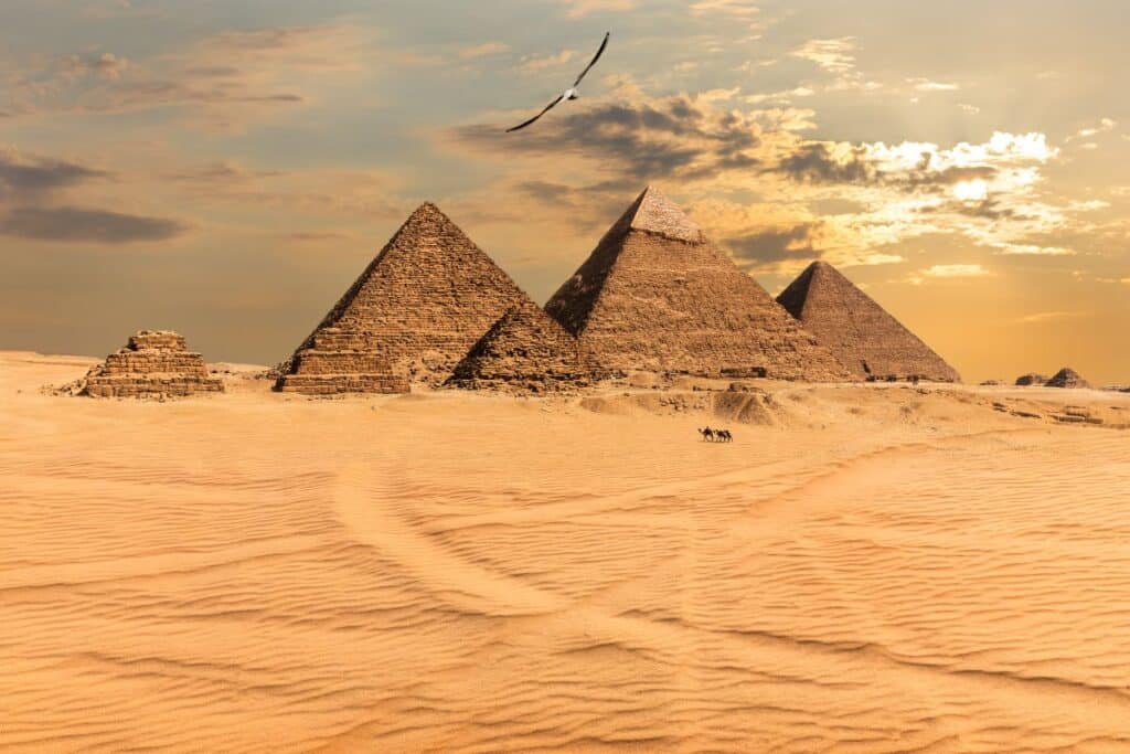 Sunset over the Giza Pyramids in Egypt, highlighting the silhouette of the Great Pyramid